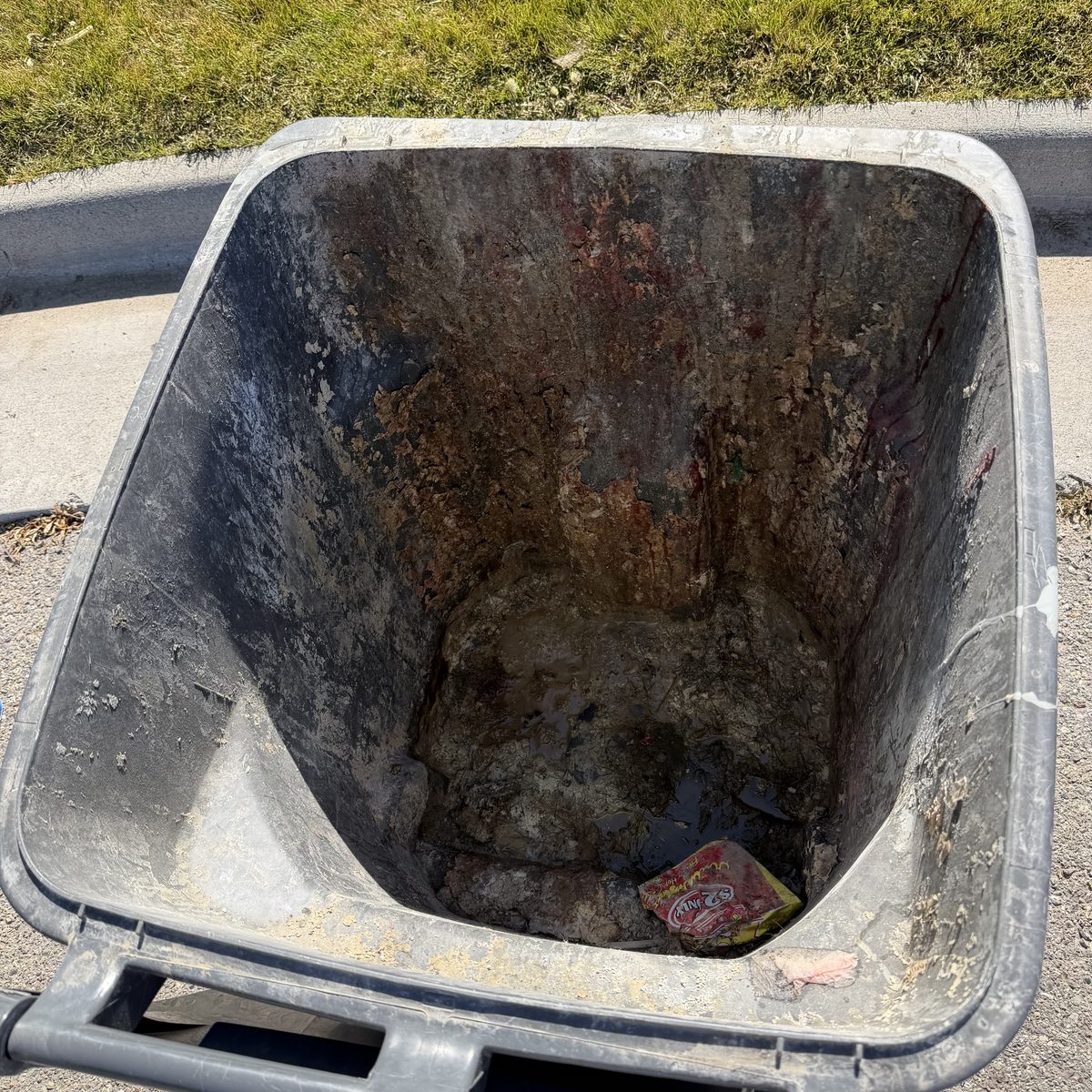 Garbage can before cleaning — caked with grime and food residue